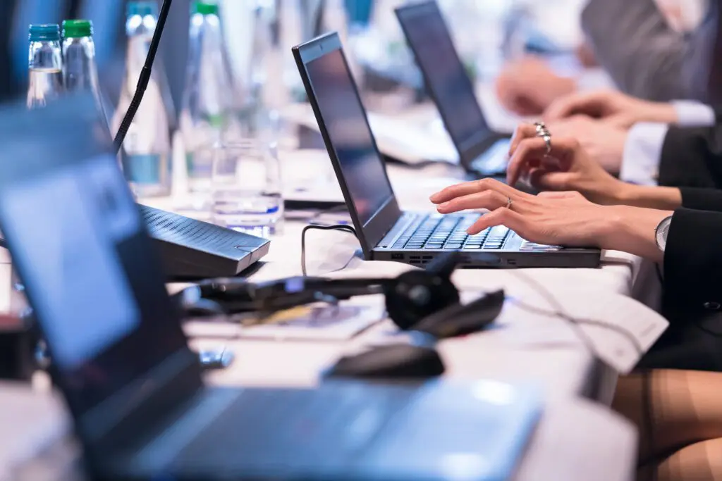 close up of business people hands using laptop computer