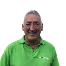 Smiling member of staff with green polo