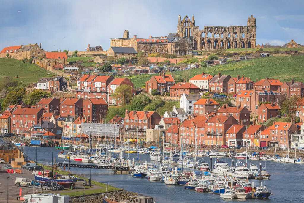 View of Whitby townscape and Whitby Abbey over the River Esk on a sunny afternoon.